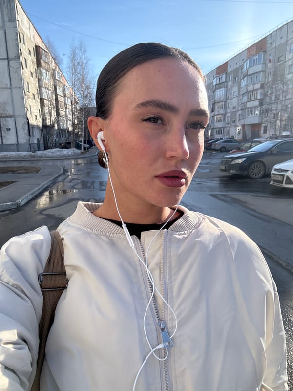 Person with earphones stands on residential street in Surgut
