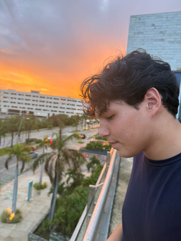 Cancún sunset from a balcony, sky lit up orange