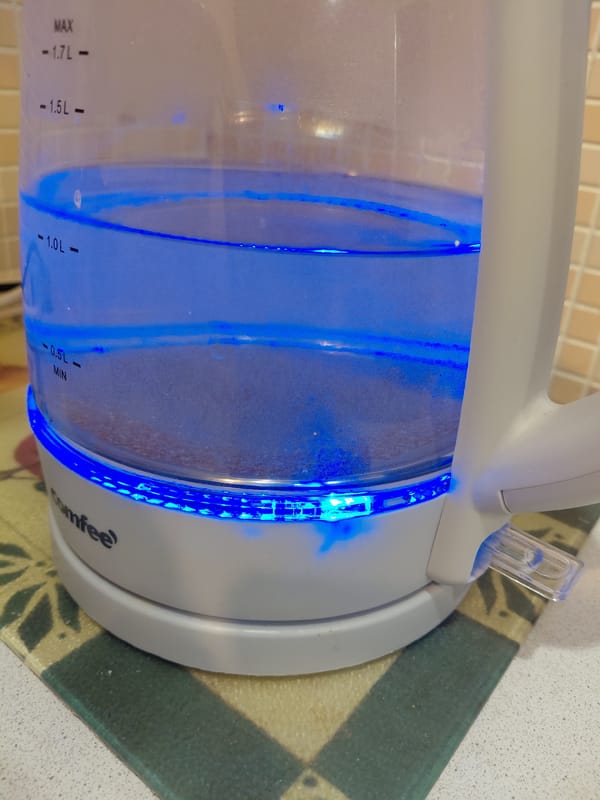 Electric kettle heating water with blue LED in Nadym
