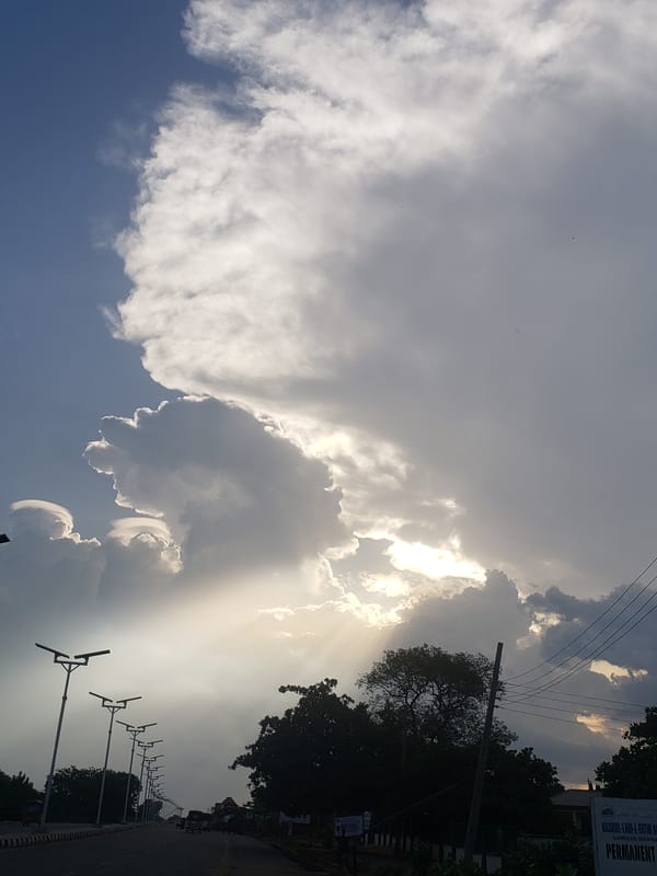 Dramatic sunbeams pierce clouds over Adankolo, Nigeria