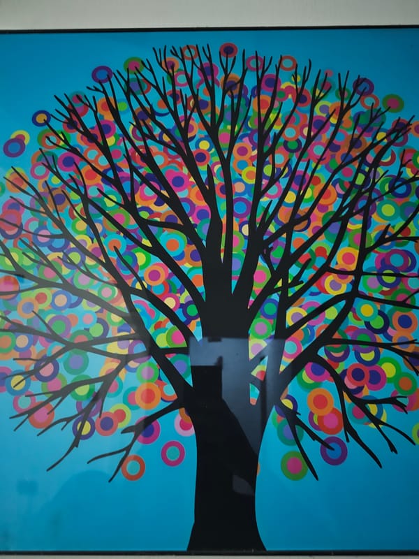 Colorful tree artwork with circles observed in frame