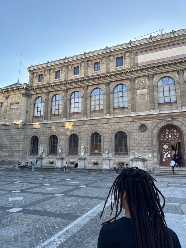 Parisians explore art school courtyard during evening hours
