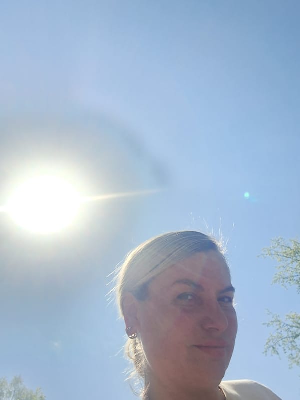 Blonde woman with earring observed from low angle