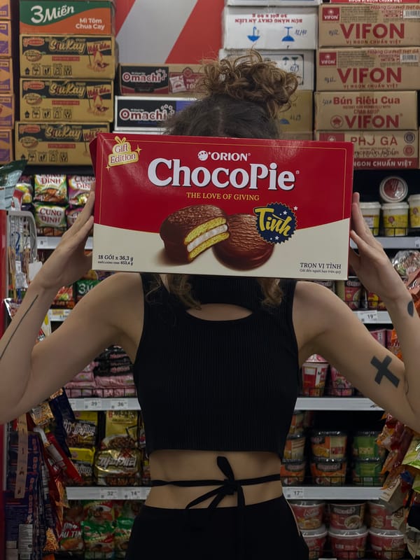 Shopper poses with ChocoPie box covering face in Đà Nẵng supermarket