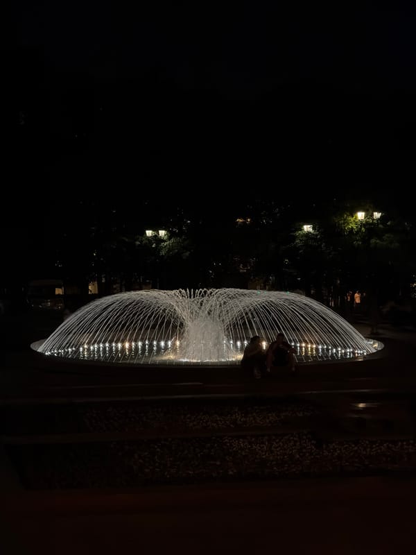 Evening fountain scene witnessed in Moscow with figures nearby