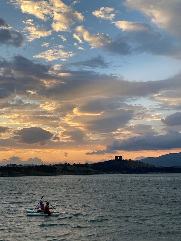 Paddleboarding on Tbilisi Sea at a dramatic summer sunset