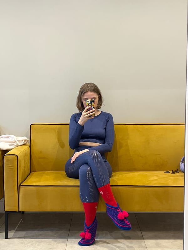 Woman relaxes on yellow sofa in Novosibirsk home