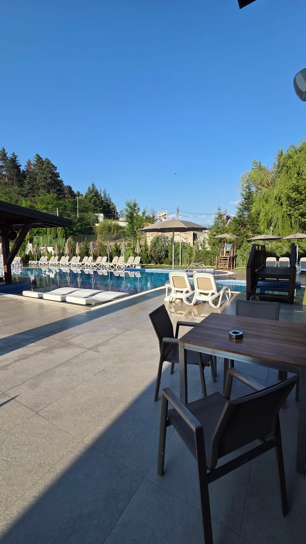 Pool area and restaurant at a leisure property, day to dusk