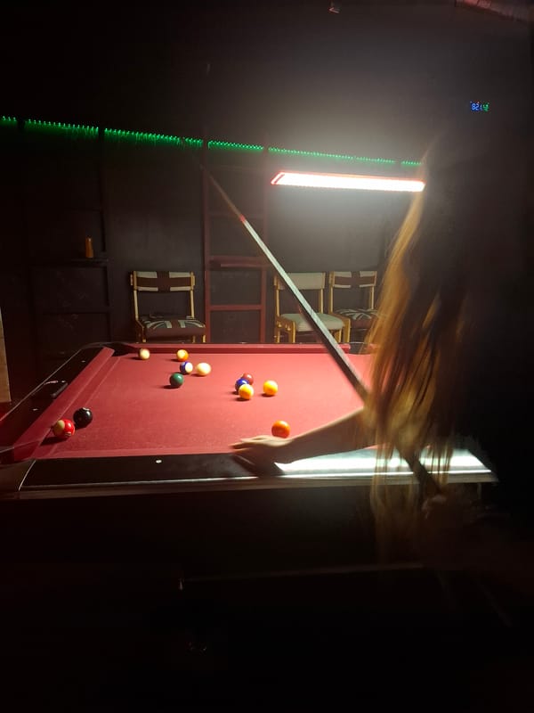 Pool game captured in dimly lit Veliko Tarnovo venue