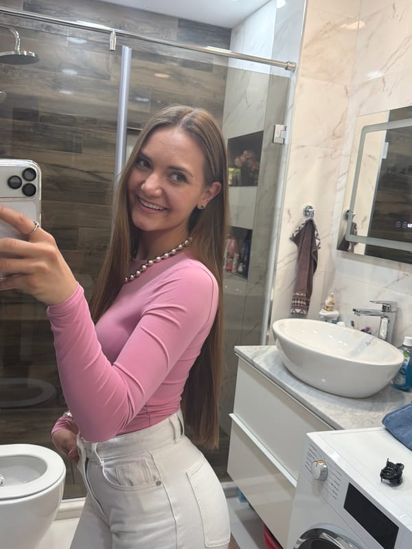 Woman takes mirror selfies in Buhovo bathroom