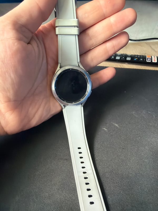 Person holds smartwatch in Chaikovsky, Russia morning scene