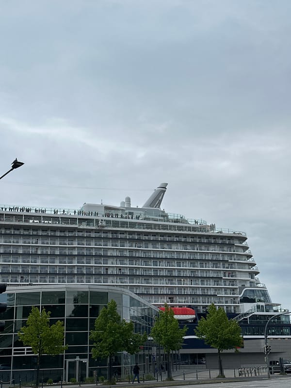 TUI cruise ship docked at Kiel port, passengers visible