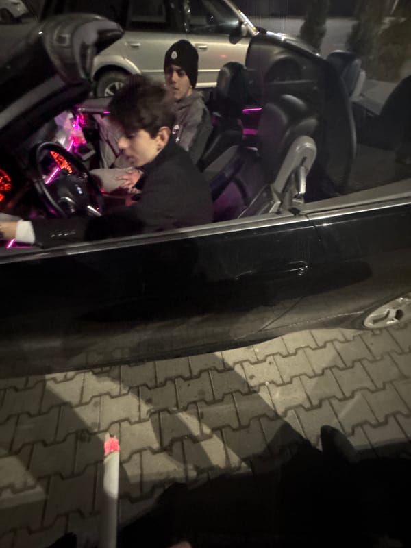 Two people drive through Targovishte city streets at night