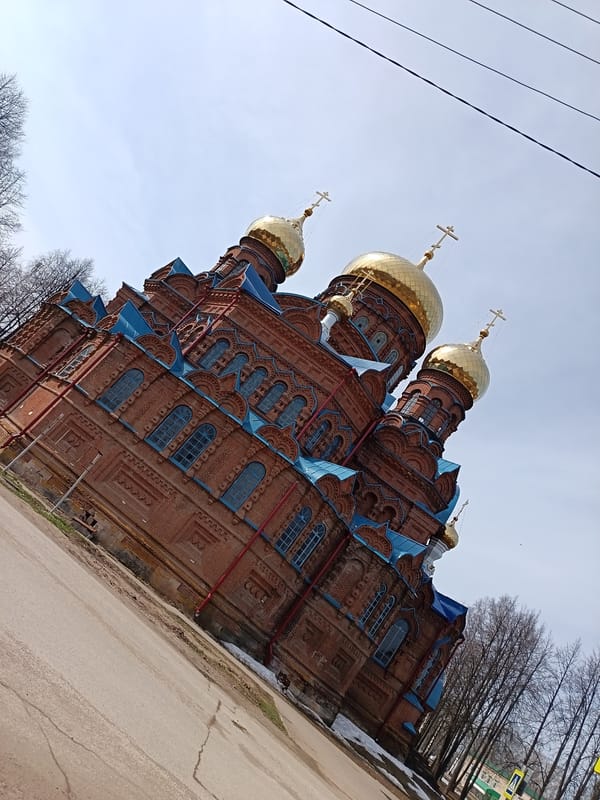 Woman photographs herself at Holy Trinity Cathedral in Osa
