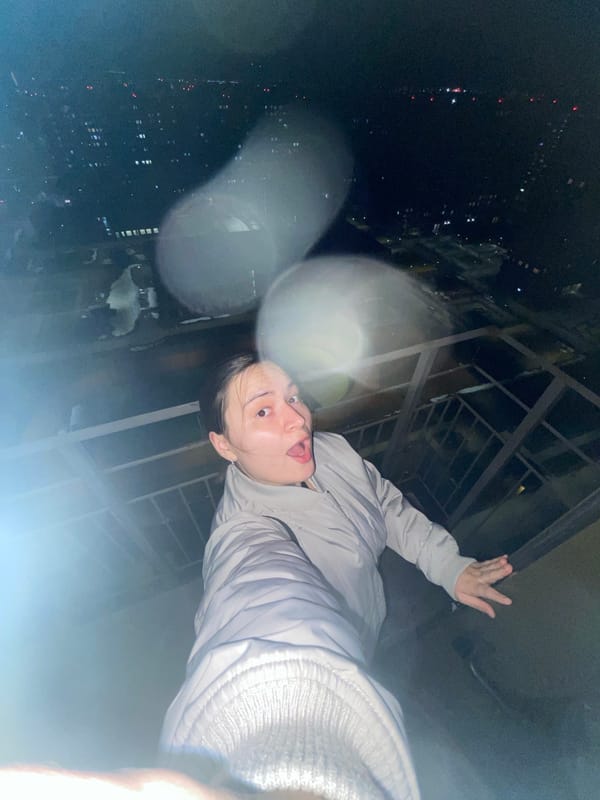 Person takes playful nighttime selfie on rooftop in Balashikha