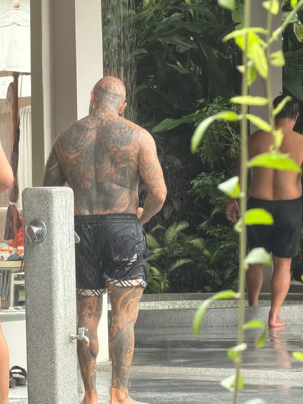 Fresh tattoo aftercare at an outdoor rinse station in Choeng Thale