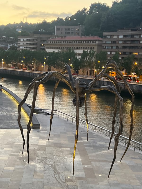 Bilbao's riverfront landmarks at dusk, Guggenheim to Zubizuri