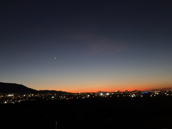 Twilight cityscape captured in Sofia with bright sky object