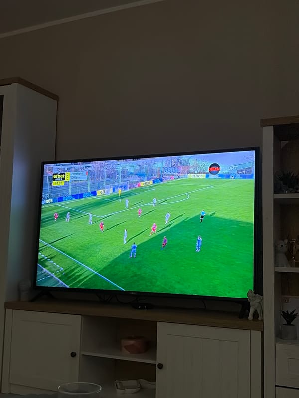 Soccer game broadcast viewed on mounted television in Bulgaria