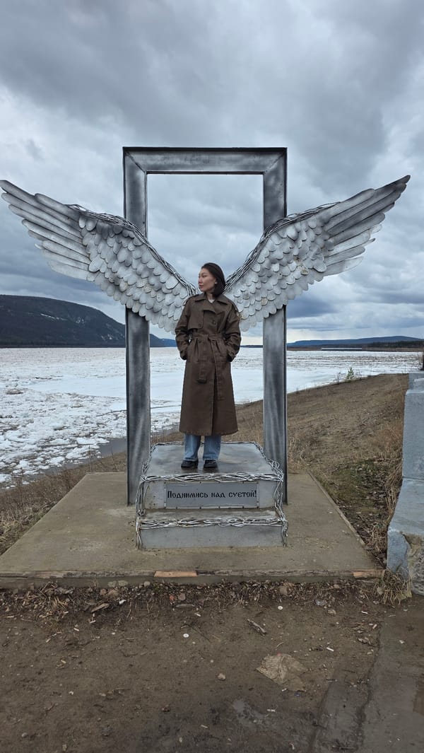 Woman poses in angel wings sculpture in Lensk, Russia