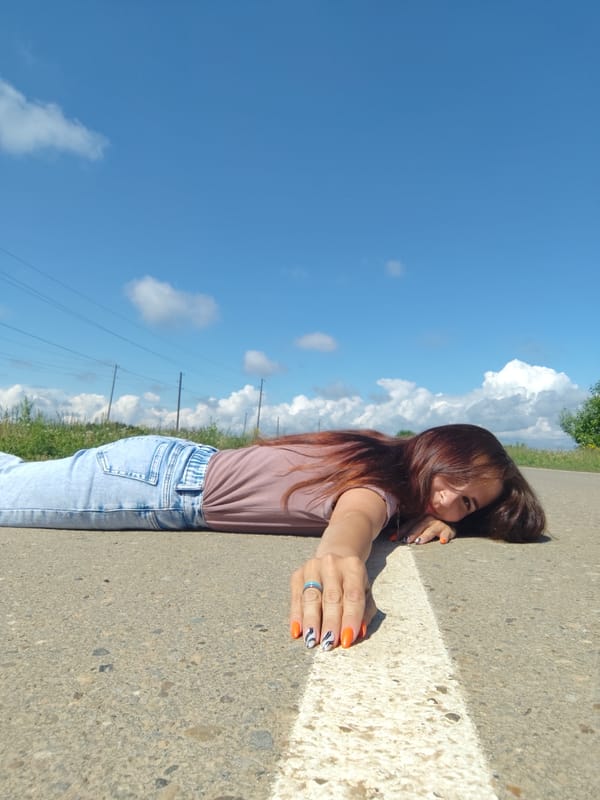 Woman poses for photos on rural road in Фоки, Russia
