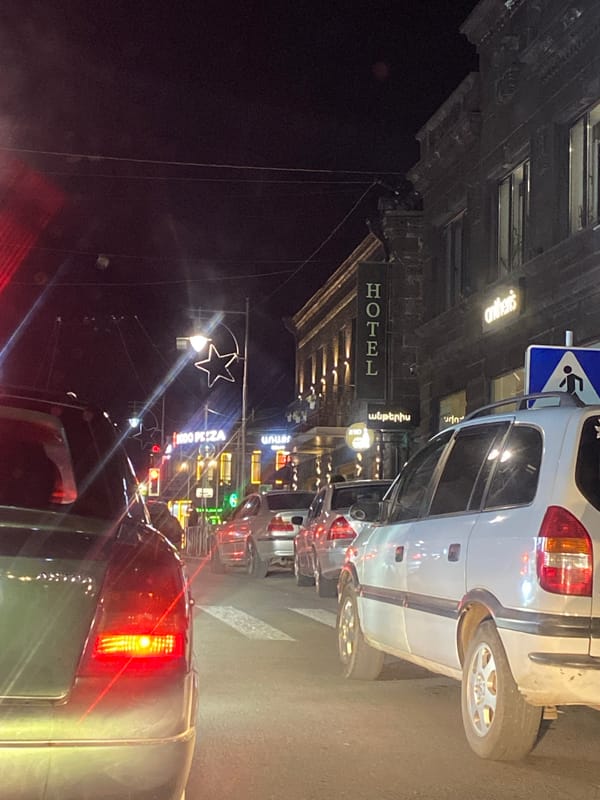 Gyumri streets at dusk: traffic, fountains, and nightlife