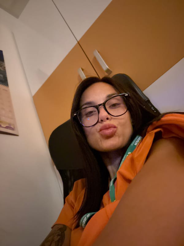 Indoor selfie with orange shirt and green lanyard, Pleven