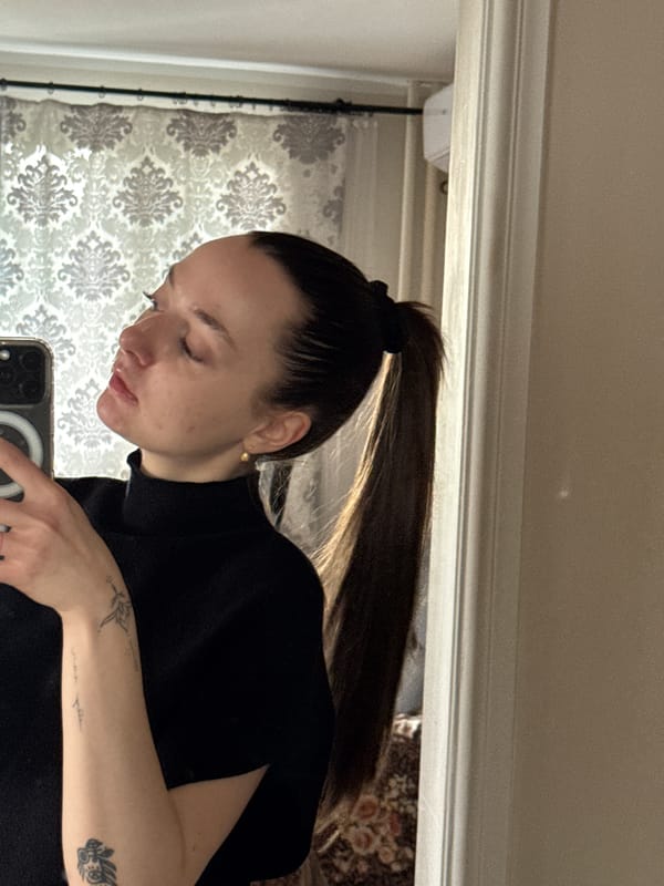 Woman documents morning routine with selfies and cat in Serbia