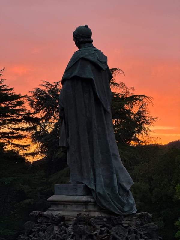 Sunset light over Alameda Park statues and trees, Santiago de Compostela