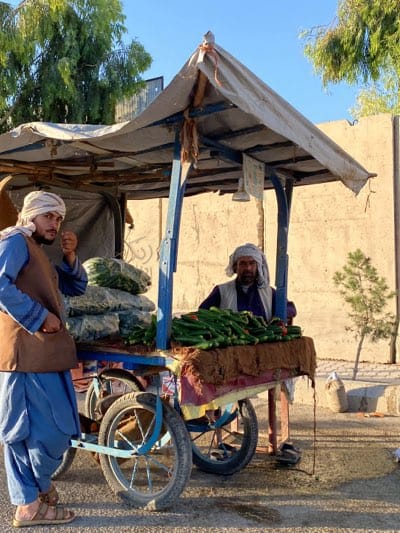 Street vendors sell produce from carts in Kandahar
