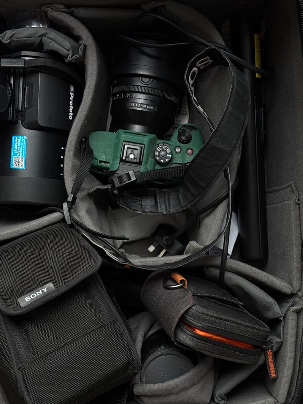 Photographer organizes equipment in camera bag in Dubai