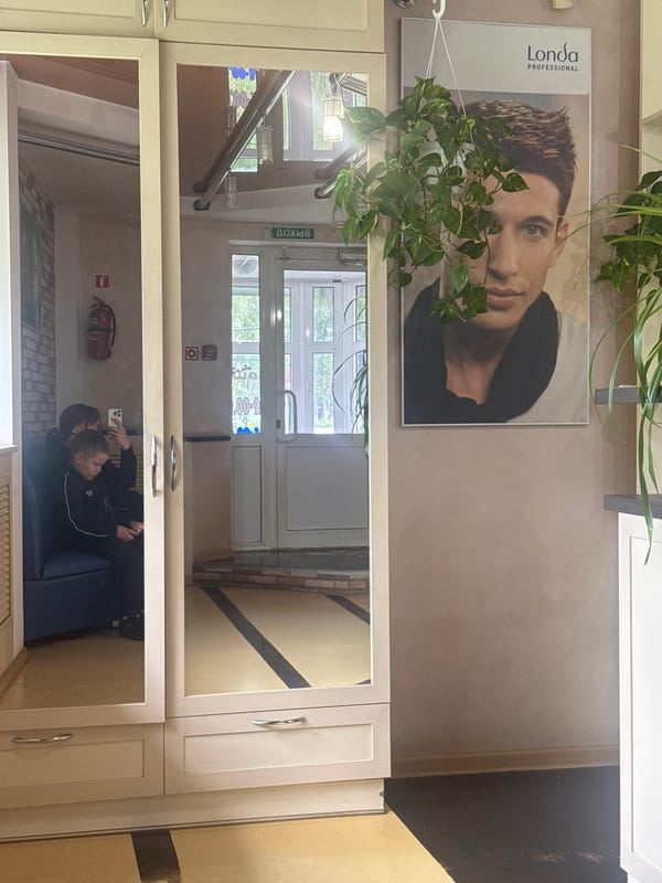 Woman and child photographed in Chaikovsky transit station waiting area