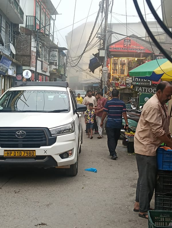 Foggy morning on a busy narrow street in Bhagsu, India