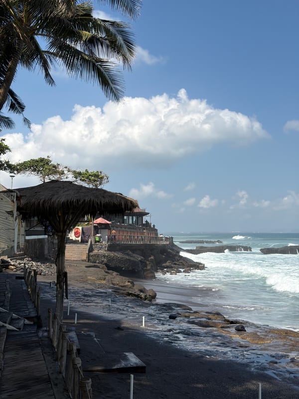 Rough surf and stormy skies hit North Kuta's black sand shore