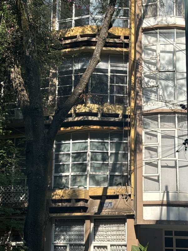 Residential buildings observed with laundry, vegetation, parked vehicle