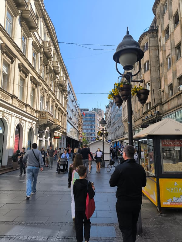 Sunny day pedestrian activity observed on Belgrade street