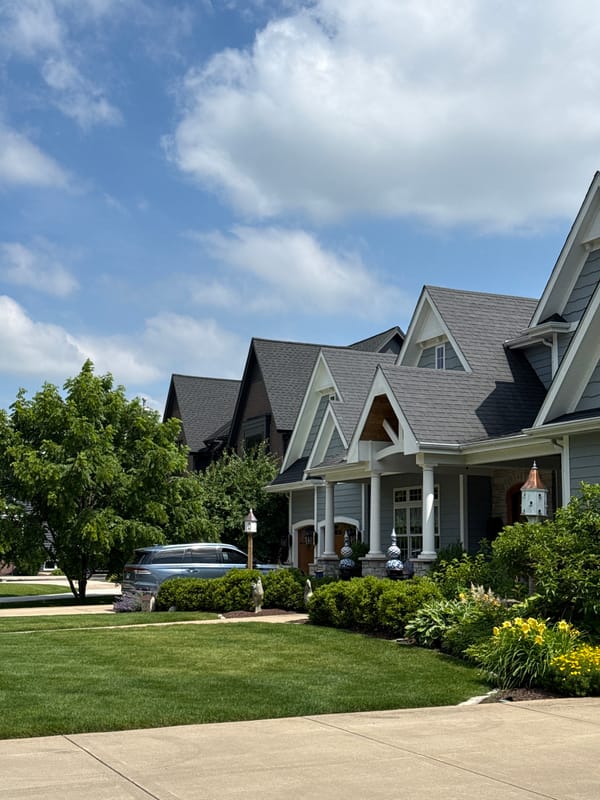 Multi-story home with blue siding and gabled dormers in Naperville