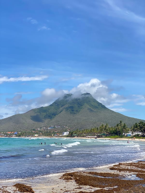 Colorful fishing boats line the shore at El Tirano beach