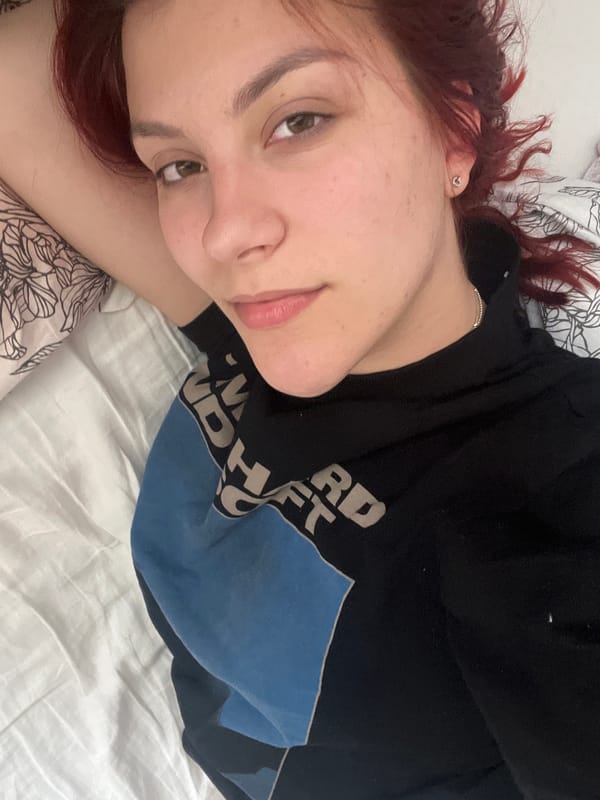 Woman rests on bed in Sofia apartment