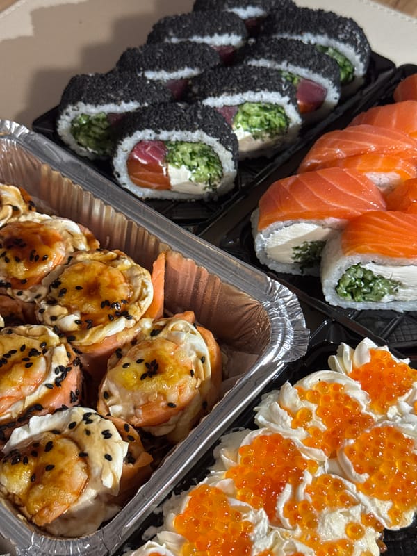Overhead look at a sushi spread in takeout containers