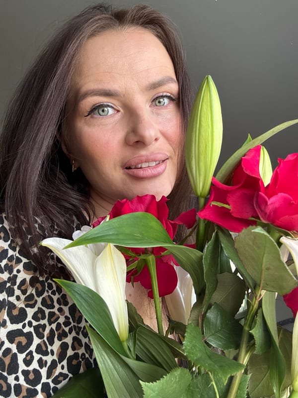 Woman poses with flower bouquet in Rusalevka portrait session