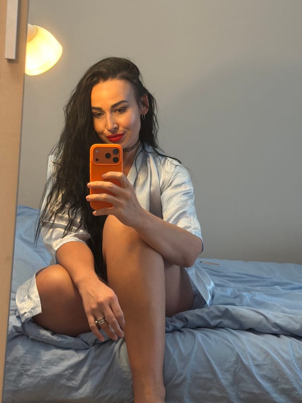 Woman takes bedroom selfies during afternoon photo session