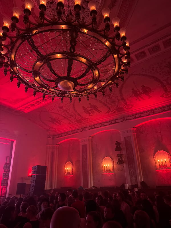 Red-lit Moscow venue with an ornate chandelier overhead
