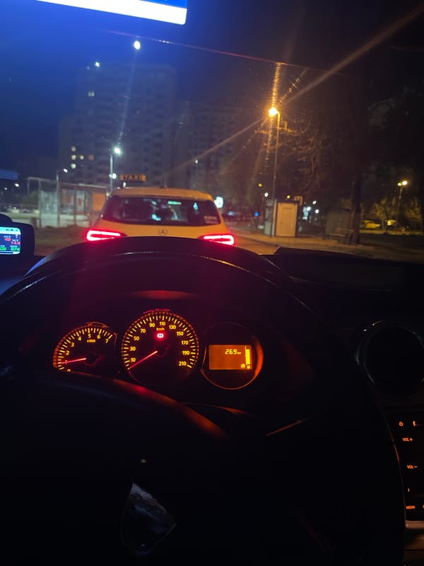 Driver stopped behind taxi during nighttime in Sliven, Bulgaria