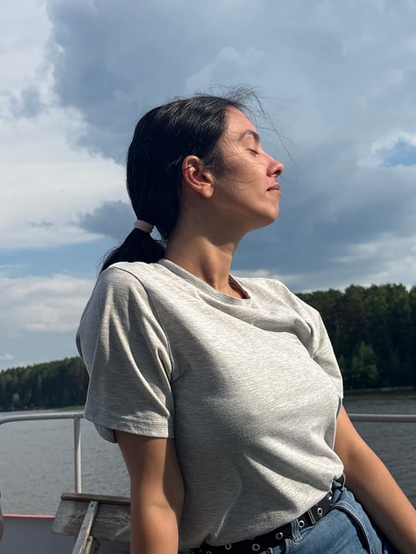 Woman enjoys quiet boat moments under cloudy skies in Chaykovsky