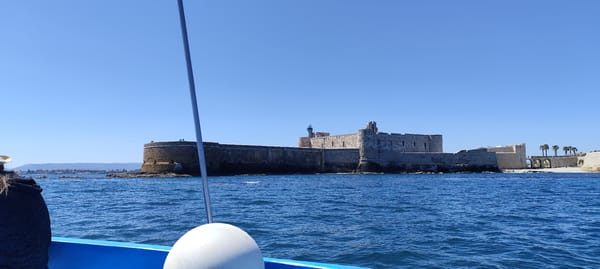 Boat tour captures Castello Maniace fortress near Syracuse Italy