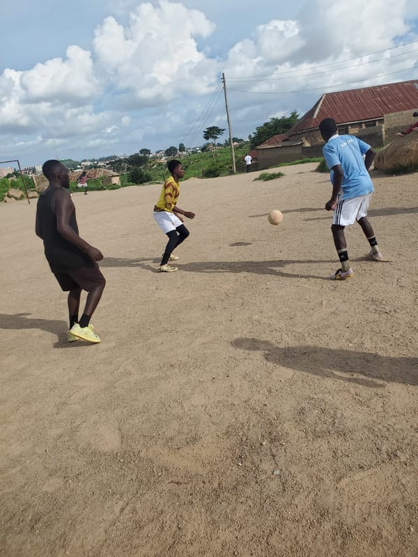 Pickup soccer on a dirt field in Jos, Nigeria