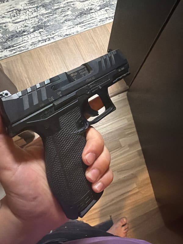 Individual handles firearm and beer in Shumen indoor setting