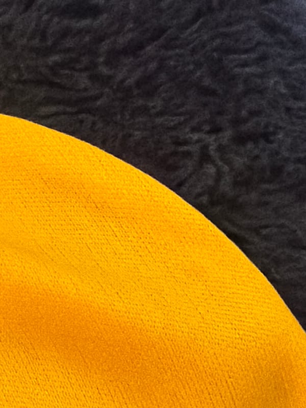Scattered close-ups of fabrics, a phone, and digital art in Rome