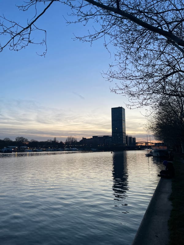 Berlin waterfront gathering captures sunset moment along city river